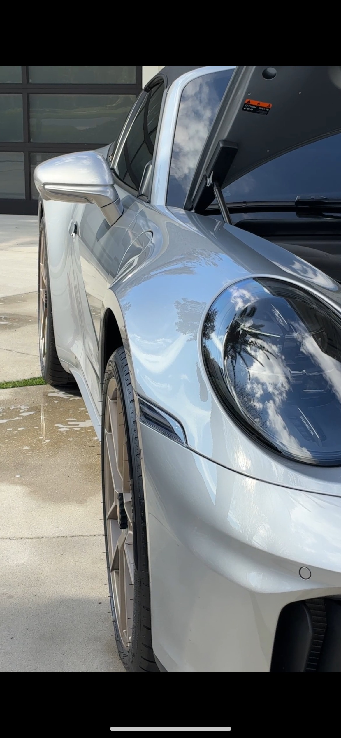 Porsche 911 ceramic coating closeup - mirror-like paint reflection